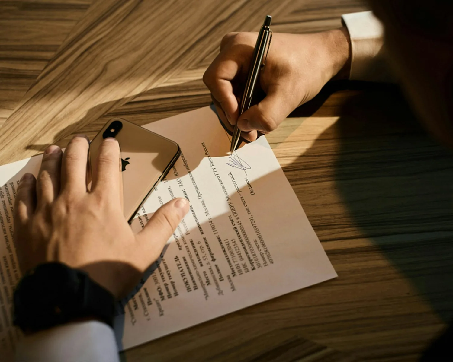 A person signing a power of attorney for a property purchase in Greece.